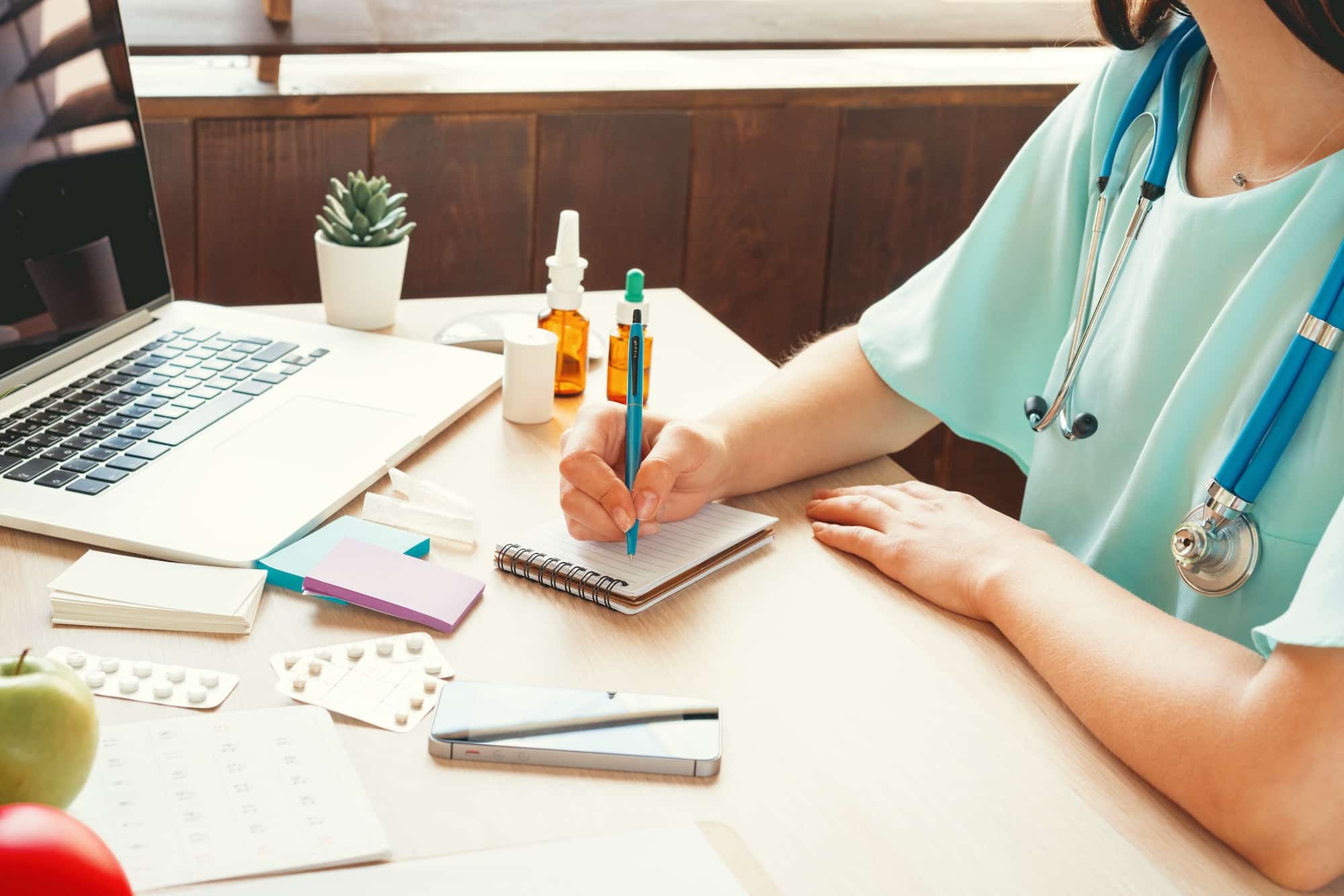 Female medicine doctor filling patient medical form or prescription